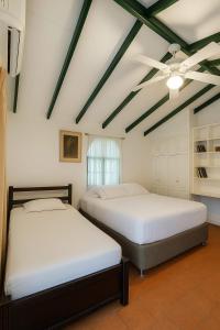 Ένα ή περισσότερα κρεβάτια σε δωμάτιο στο Casa Paula acosta santa marta