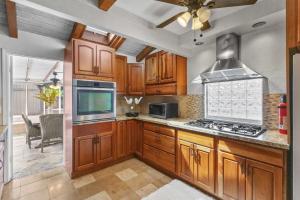 a kitchen with wooden cabinets and a stove top oven at Hale Kulamanu in Hauula