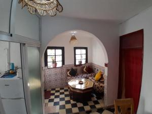 a living room with a couch and a table at Arch Guesthouse - Dorm for Budget Travelers in Tangier in Tangier