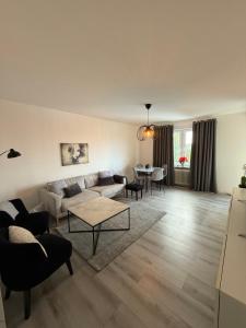 a living room with a couch and a table at Whole 3-room apartment, 10 min from malmo C & 2 min from shops in Malmö