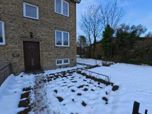 a house with snow on the ground in front of it at Whole 3-room apartment, 10 min from malmo C & 2 min from shops in Malmö