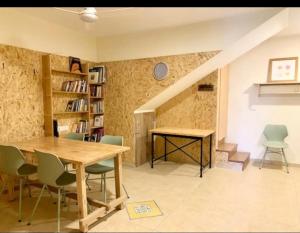 a dining room with a wooden table and chairs at מתחת לעץ התות בכפר in Bet Alfa