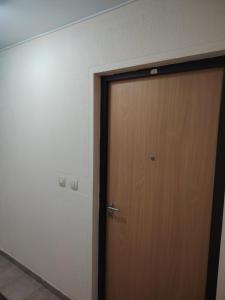 a wooden door in a room with a wall at Sicilija apartment in Podgorica