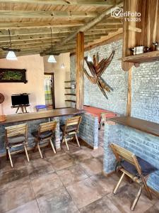 un restaurant avec un bar et des chaises dans une salle dans l'établissement Punta Avellaneda, à Punta del Diablo