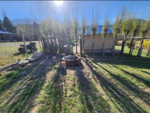 a backyard with a fire pit in the grass at Cabañas Pie del Plata in Mendoza
