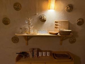 a shelf on a wall with plates and bowls on it at Asfay Lodge Siwa in Siwa +99 photos