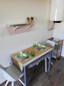 a dining room table with plates and dishes on it at HOUSE 4U - Modern Mezzanine Apartment with AC, Wi-Fi and Parking - Abrantes in Abrantes