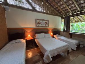 En eller flere senge i et værelse på CASA DE VIDRO