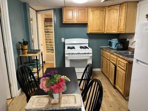 a kitchen with a table with flowers on it at Cozy Efficiency Room WalktoUHS, near BU Guthrie in Johnson City