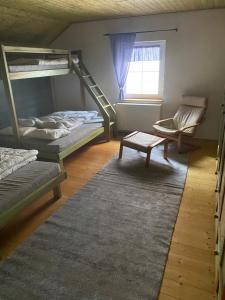 a room with two bunk beds and a window at Chata u Špičáku in Albrechtice v Jizerských horách