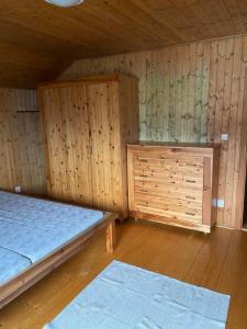 an empty room with two beds and a cabinet at Chata u Špičáku in Albrechtice v Jizerských horách