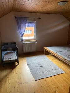 an attic room with a bed and a window at Chata u Špičáku in Albrechtice v Jizerských horách