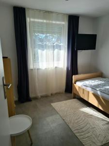 a bedroom with a bed and a window at Ferienwohnung Lösel in Freilassing