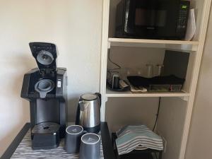 a coffee maker and a microwave on a shelf at Super Comfortable in San Carlos