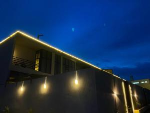 a building with lights on the side of it at night at albaha harmony resort in Al Baha +17 photos