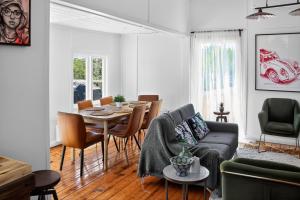 a living room with a couch and a table and chairs at Cedar Cottage Daylesford in Daylesford