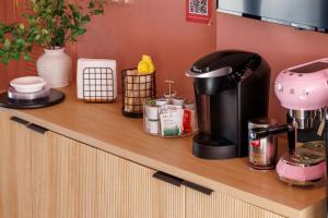 a counter with a coffee maker and other items on it at The Muse Hotel in Palm Springs