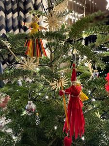 a christmas tree with christmas ornaments on it at Domek Tatry - Stacja Wierchowa 972 m in Brzegi +92 photos