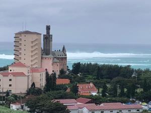 a large castle on top of a town with buildings at Villa resort -悠- in Miyakojima