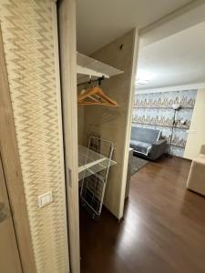 ein Zimmer mit einem Schrank mit Regal und einer Couch in der Unterkunft Alans Place to visit in Daugavpils