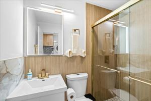 a bathroom with a toilet and a sink and a shower at 20 percent OFF Cozy Modern Suite in Tustin +45 photos