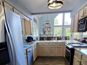 a kitchen with white appliances and a large window at Jenkins Cove Getaway in Tybee Island