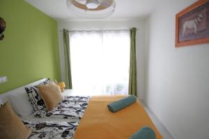 a bedroom with a bed and a large window at Sonja Apartman in Mogán +38 photos