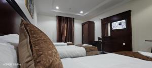 Postel nebo postele na pokoji v ubytování فندق سحر السيمت