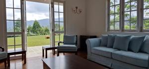 a living room with a couch and two chairs and a table at LilyRose Bungalow at Willows, Upcot, Sri Lanka  +13 photos