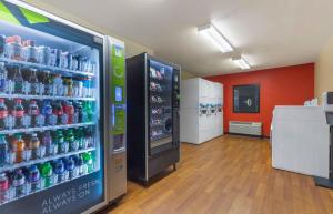 a soda vending machine in a store with soda bottles at Extended Stay America Suites - Baltimore - BWI Airport - Aero Dr in Linthicum Heights