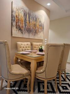 a dining room with a table and chairs at Adress cozy apartement in Sheikh Zayed