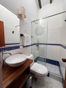 a bathroom with a sink and a toilet and a shower at Cabañas Villa Encanto in Villa de Leyva +15 photos