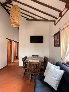 a living room with a table and a couch at Cabañas Villa Encanto in Villa de Leyva