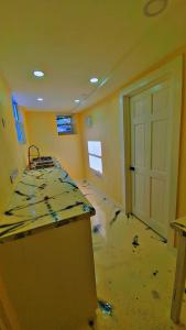 an empty room with a kitchen with a door in it at Affordable and convenient in town in Saint Georgeʼs