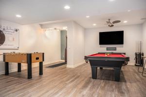 a room with a pool table and a flat screen tv at Mulligan Manor Golf Course Views Fun Amenities in Omaha