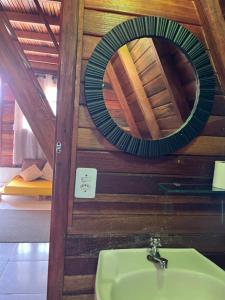 a bathroom with a sink and a mirror at Chalé Mirante das Estrelas in Camanducaia