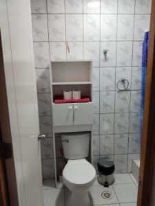 a bathroom with a white toilet in a room at Hostal Ribera de Quitor in San Pedro de Atacama
