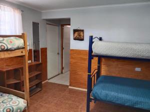 a room with two bunk beds and a hallway at Hostal Ribera de Quitor in San Pedro de Atacama