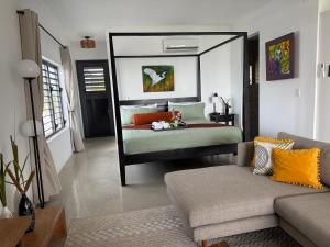 a bedroom with a bed with a large mirror at Pelican at Galley Bay View in Five Islands Village