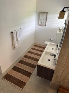 a bathroom with a sink and a toilet at Pelican at Galley Bay View in Five Islands Village