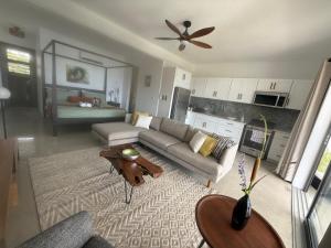 a living room with a couch and a table at Pelican at Galley Bay View in Five Islands Village