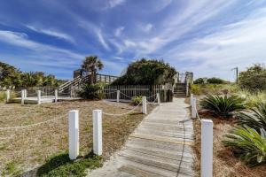 a wooden boardwalk leading to a house on a beach at SC304A: 304A Sea Cabin in Isle of Palms
