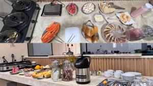 a kitchen with a counter top with food and dishes at Piritiba Hotel in Mato Verde
