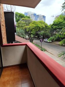 a balcony with a red covering on a building at Casa de hospedaje Lili - Cali in Cali