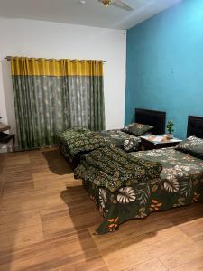 Postel nebo postele na pokoji v ubytování Green Hills Villa + 10 fotografií