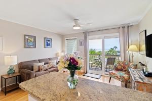 a living room with a vase of flowers on a counter at SC206A: 206A Sea Cabin in Isle of Palms