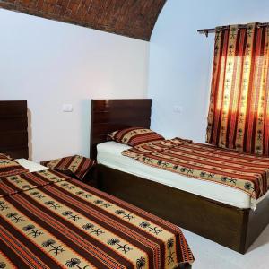 zwei Betten in einem Zimmer mit zwei Betten sidx sidx sidx in der Unterkunft nubian yellow desert in Assuan