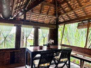 a dining room with a table and two chairs at Cozy Paradise in Battambang