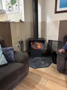 a living room with a fireplace and a couch at Naracoorte Central Accommodation in Naracoorte