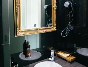a bathroom with two sinks and a mirror at &Tales Hotel - Óbidos in Óbidos